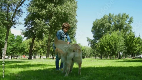 Cheerful little boy enjoying time with his dog