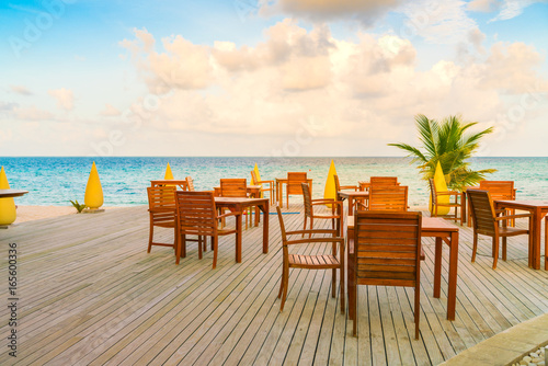 Table and chairs at restaurant in tropical Maldives island . © jannoon028