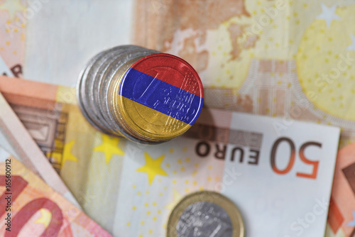 euro coin with national flag of armenia on the euro money banknotes background