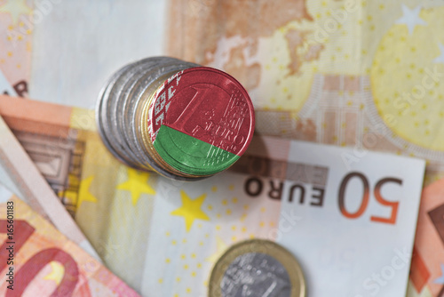 euro coin with national flag of belarus on the euro money banknotes background
