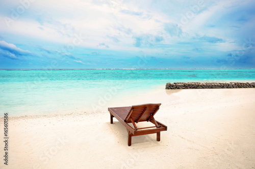 Sun lounger on beach in summer day © Africa Studio