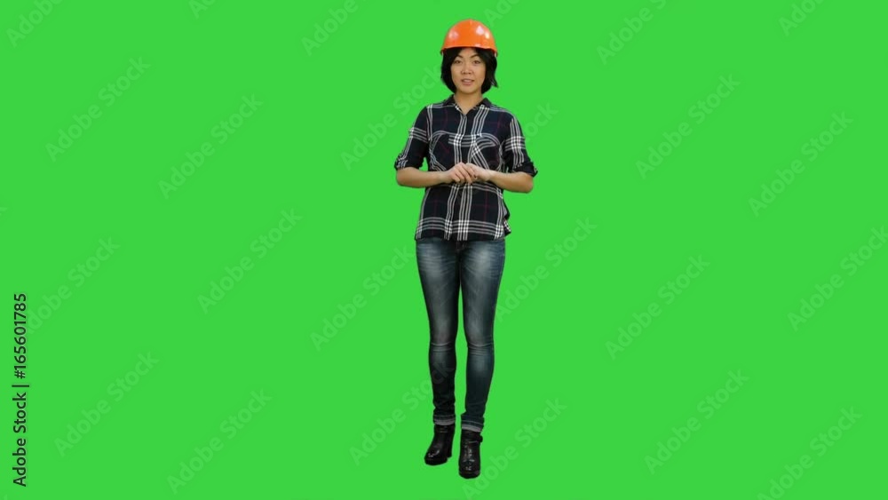 Asian engineer with helmet talk to a camera on a Green Screen, Chroma Key Asian engineer with helmet talk to a camera on a Green Screen, Chroma Key
