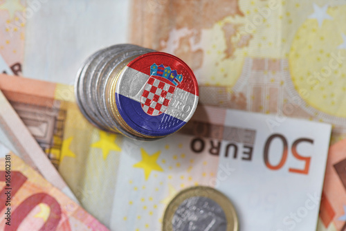 euro coin with national flag of croatia on the euro money banknotes background.