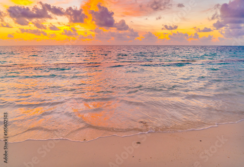 Beautiful sunset with sky over calm sea in tropical Maldives island . © jannoon028