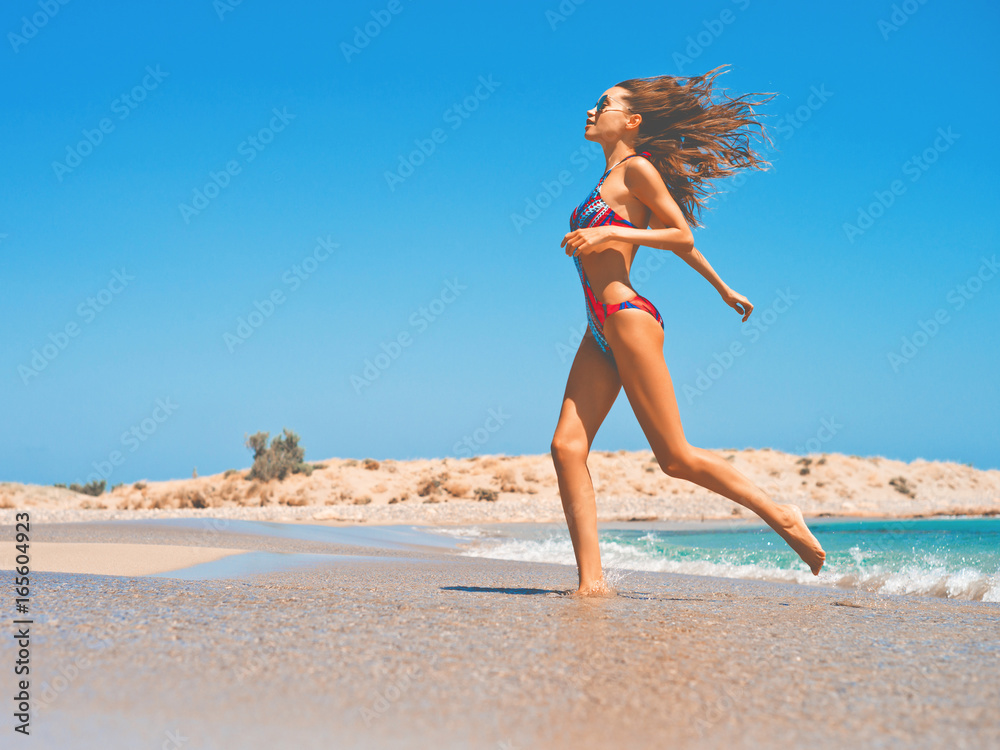 Naklejka premium Beautiful happy slender woman at sea