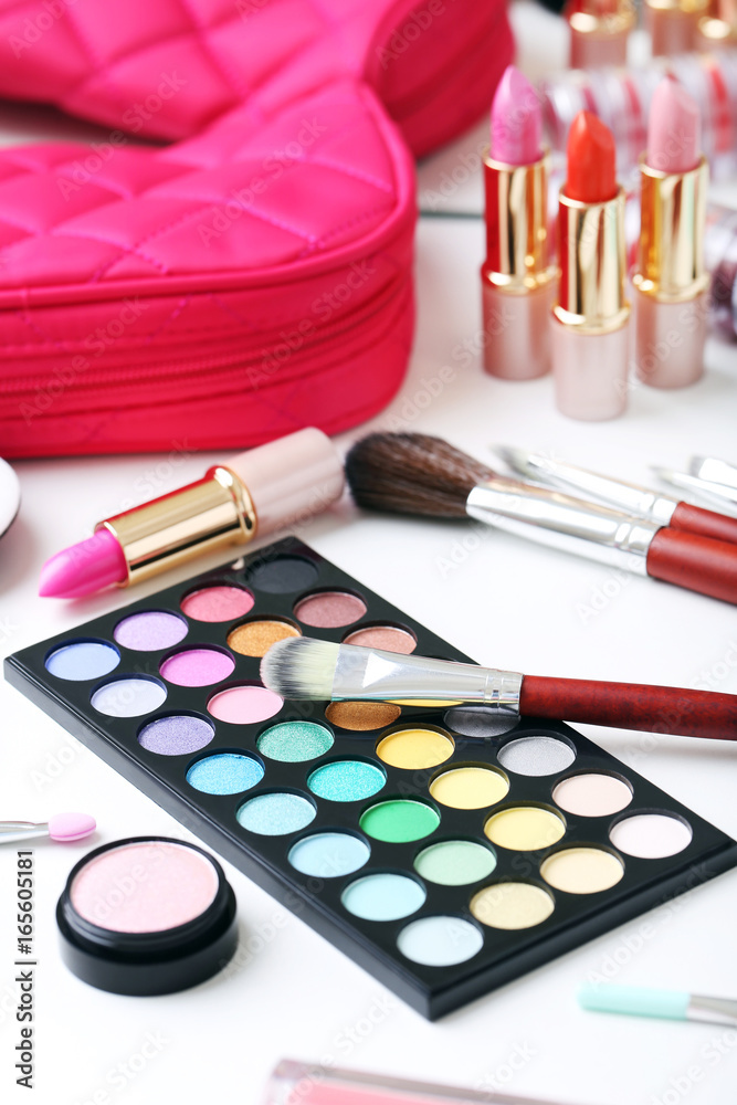 Different makeup cosmetics on white table Different makeup cosmetics on white table