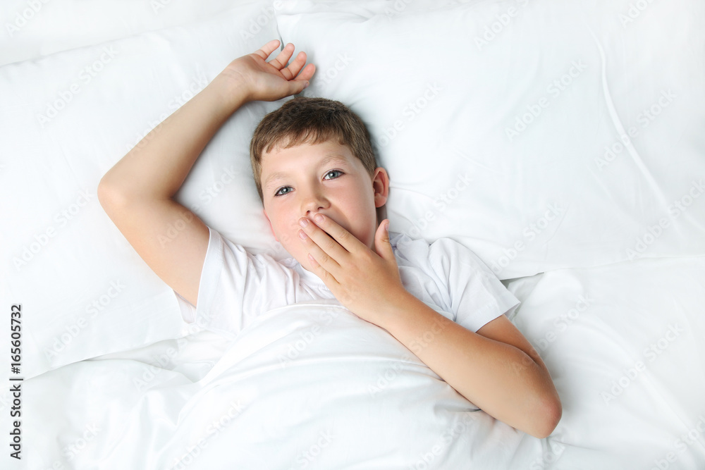 Young boy sleeping in white bed Young boy sleeping in white bed