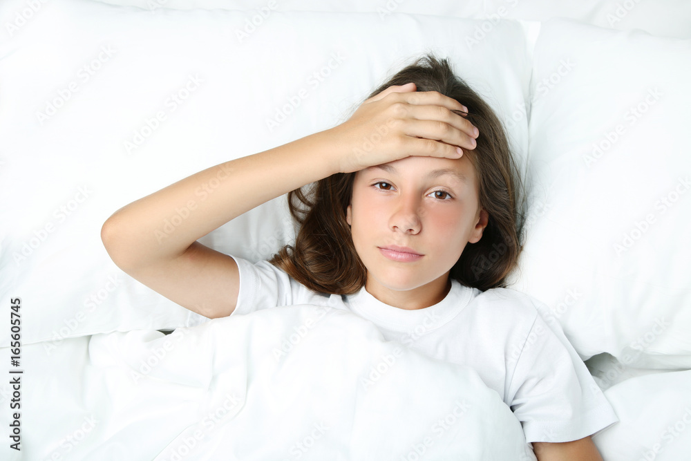 Sick girl lying in white bed Sick girl lying in white bed