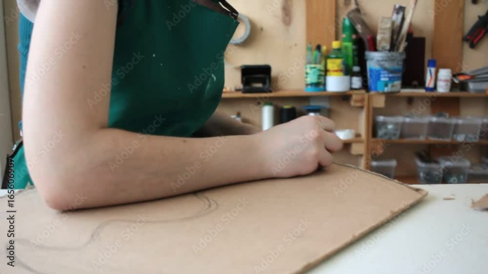 Woman in workshop cutting wood Woman in workshop cutting wood