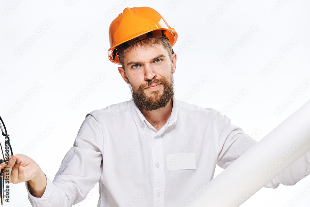Engineer with a beard on a white isolated background holds blueprints