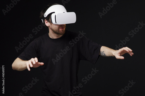 Man in vr headset crossing virtual space, moving against black background