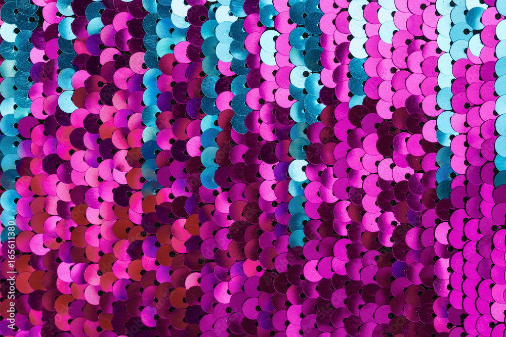 Sequins close-up macro. Abstract background with blue sequins and lilac color on the fabric. Texture scales of round sequins with color transition . Sequins close-up macro. Abstract background with blue sequins and lilac color on the fabric. Texture scales of round sequins with color transition .