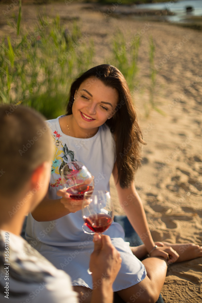 A young couple in love, on the shore of the Bay at sunset A young couple in love, on the shore of the Bay at sunset