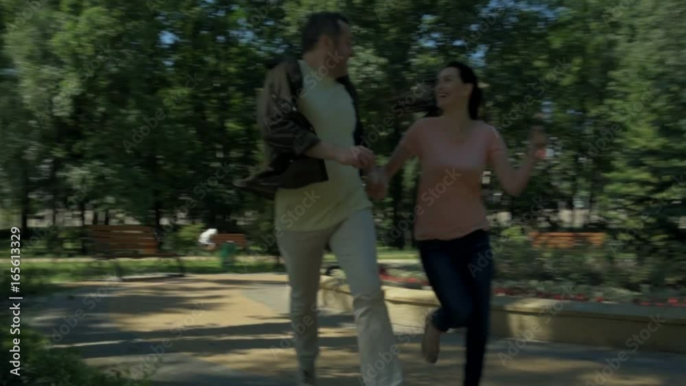 Joyful couple running in the park Joyful couple running in the park