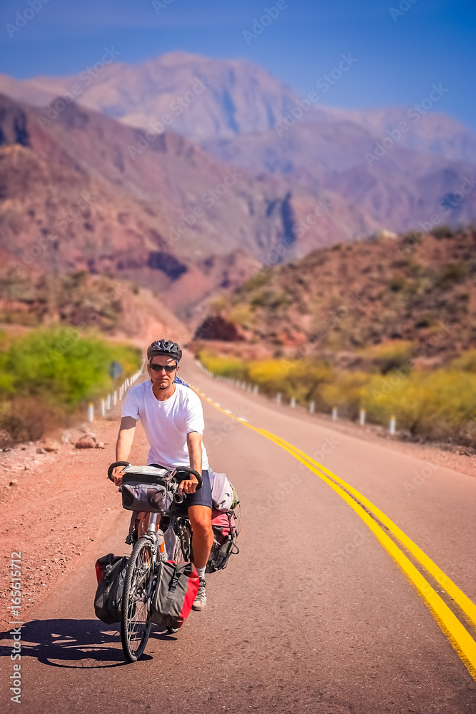 Man cycling on the empty road to Cafayate