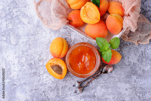 Apricot jam in glass jar photo