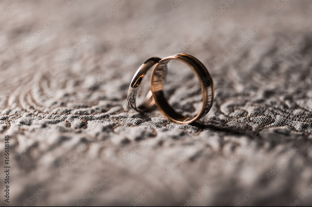 Couple close-up of engagement gold wedding rings Couple close-up of engagement gold wedding rings