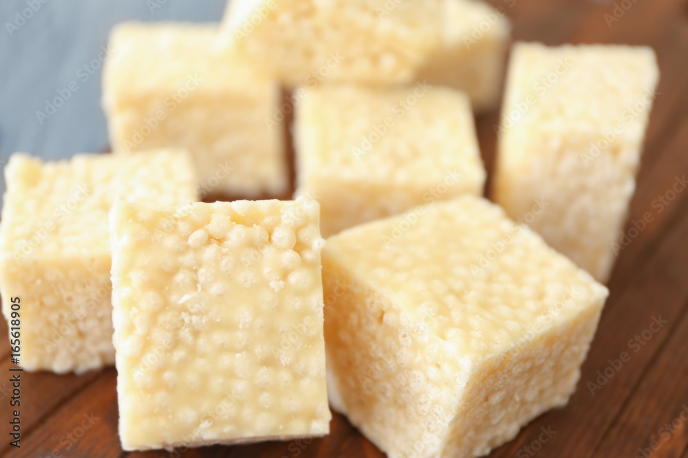 Wooden cutting board with cubes of rice treats, closeup Wooden cutting board with cubes of rice treats, closeup