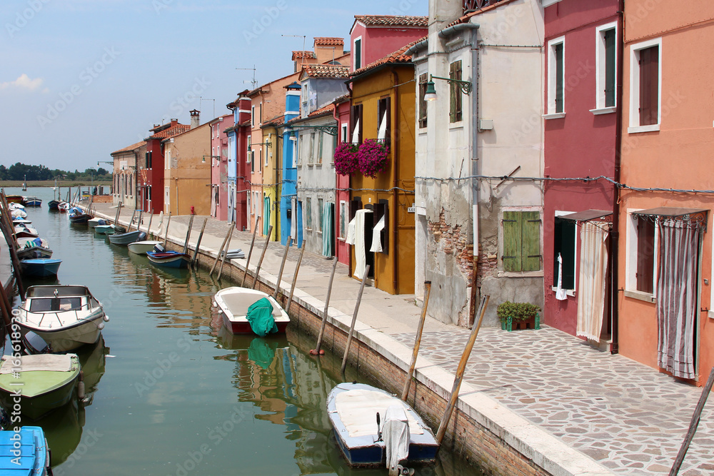 brightly coloured houses and boats on the island of Burano