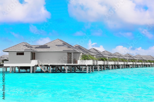 Modern beach houses on piles at tropical resort © Africa Studio