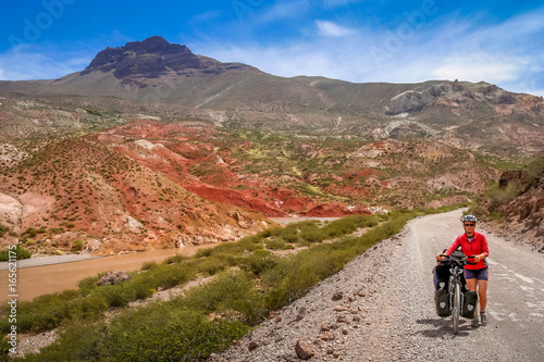 Woman cycling on the Ruta 40 Quarenta in Argentina photo