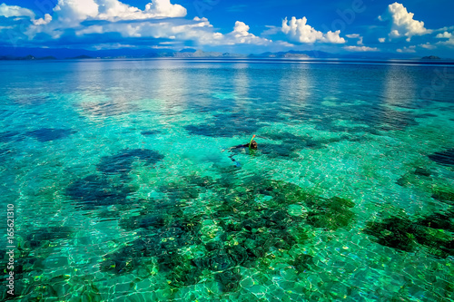 Woman snorkeling in clear ocean waters