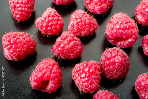 Macro of fresh raspberry on black from abowe