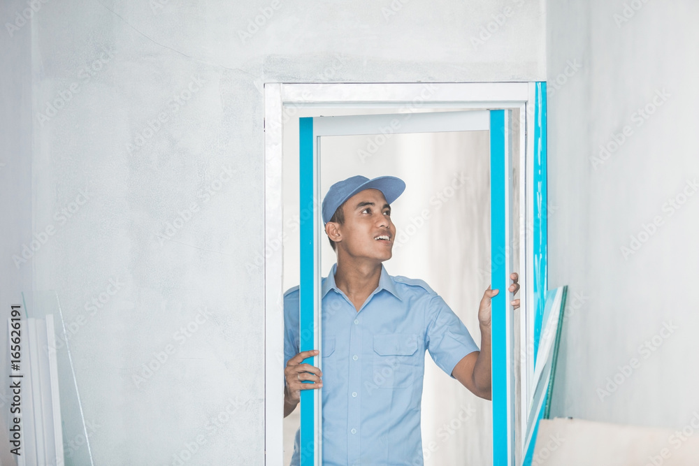 Worker installing doors
