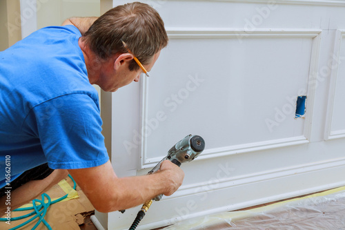 Vászonkép Gauge Finish Nailer man nailed slats custom house building contractor