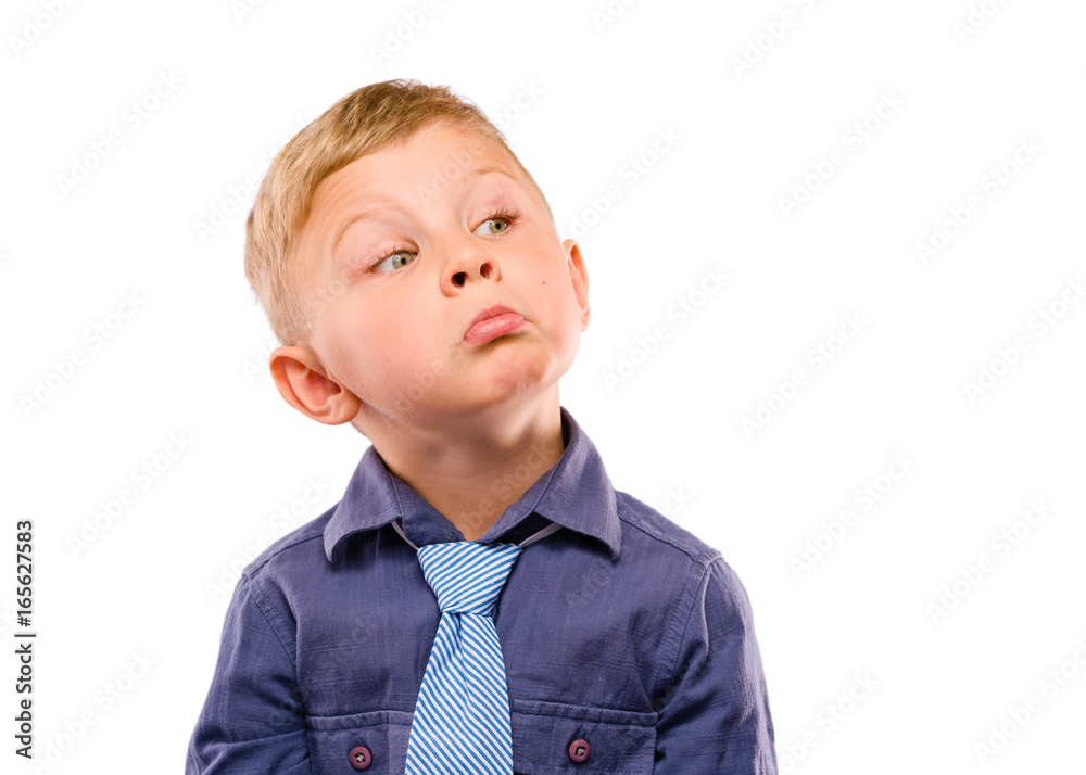 Positively Grimacing Baby Boss. Blond hair and bright eyes. Dressed in dark blue shirt with striped tie. Isolated background. Positively Grimacing Baby Boss. Blond hair and bright eyes. Dressed in dark blue shirt with striped tie. Isolated background.