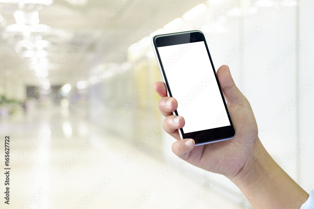 Man's hand using cellphone, Man typing text message on smart phone blurred city background Man's hand using cellphone, Man typing text message on smart phone blurred city background