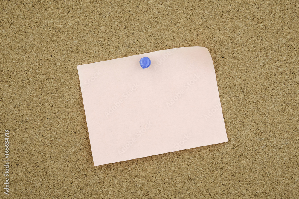 Stick note on wooden background