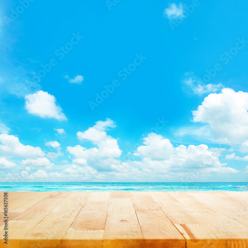 Wood table top on blue sea & sky background