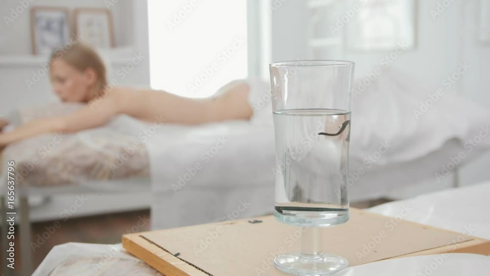 Bank with leeches against the background of a blonde girl - hirudotherapy Bank with leeches against the background of a blonde girl - hirudotherapy