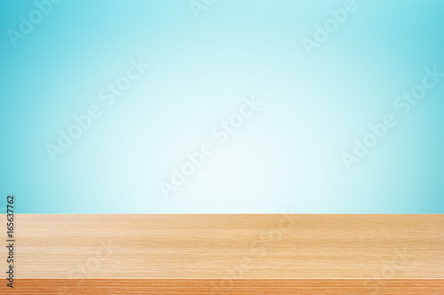 Wood table top on gradient white   blue background