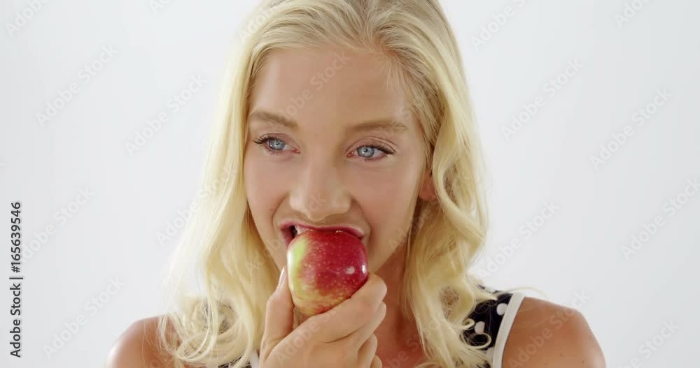 Close-up of beautiful woman eating red apple Close-up of beautiful woman eating red apple
