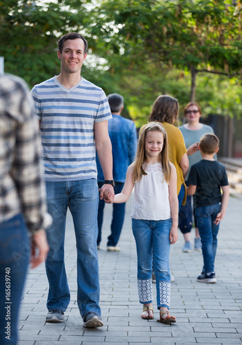 Cheerful father with little glad daughter