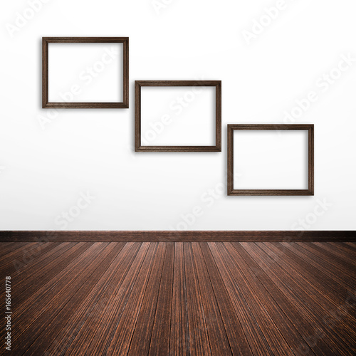 Wooden photo frames on white wall inside the room © Atstock Productions