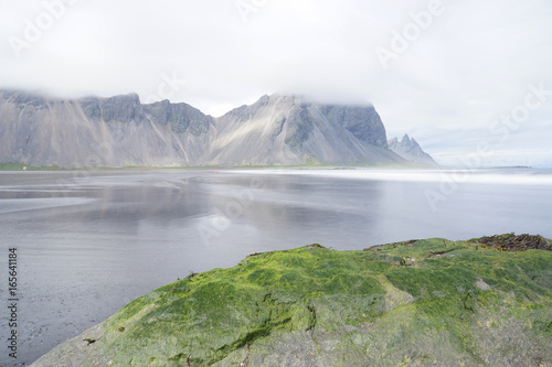 Mountains of the Vestrahorn with cloud on top holding,Iceland
