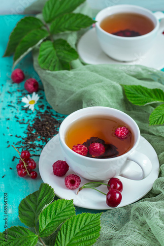 Tea with summer berries, selective focus