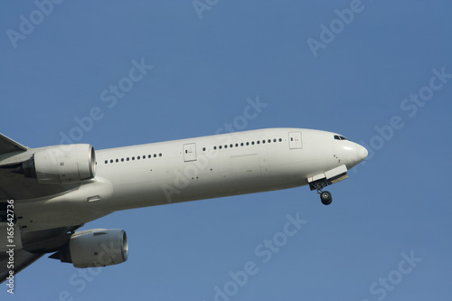 Close Up shot of Airplane Take off in Blue sky