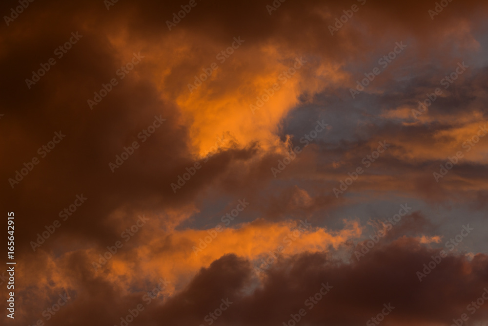 Sunset cloudscape - clouds making abstract shapes in the sky under sunset sunlight Sunset cloudscape - clouds making abstract shapes in the sky under sunset sunlight