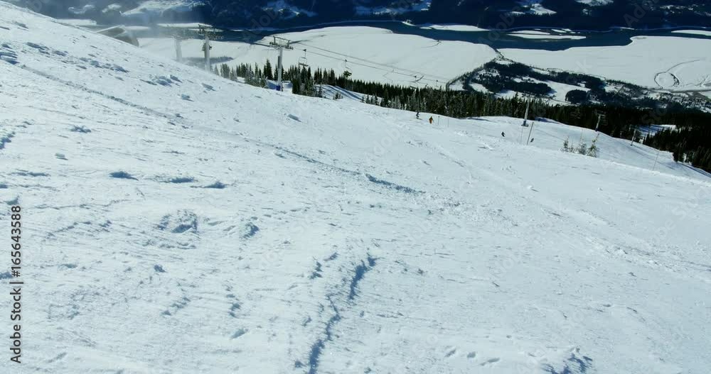 Person snowboarding on snowy mountain