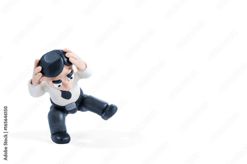 Plasticine businessman holds his hands behind his head and falls isolated on a white background Plasticine businessman holds his hands behind his head and falls isolated on a white background