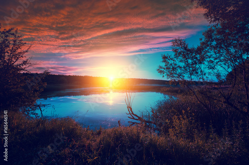 Magical sunrise over the lake. Misty morning, rural landscape, wilderness, mystical feeling © vvvita