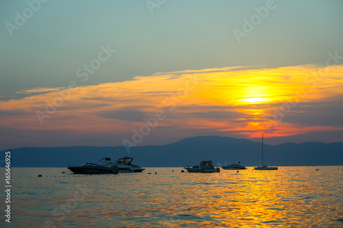 Sunset with boats at sea photo