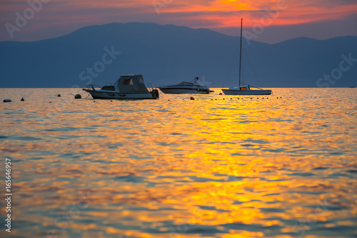 Sunset with boats at sea photo