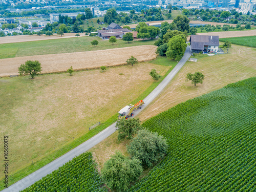Aerial view of combibe harvester on a countryside road