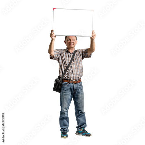 Portrait of a happy mature man standing in scott shirt and blue jeans holding the blank message board. Isolated full length on white background with copy space and clipping path