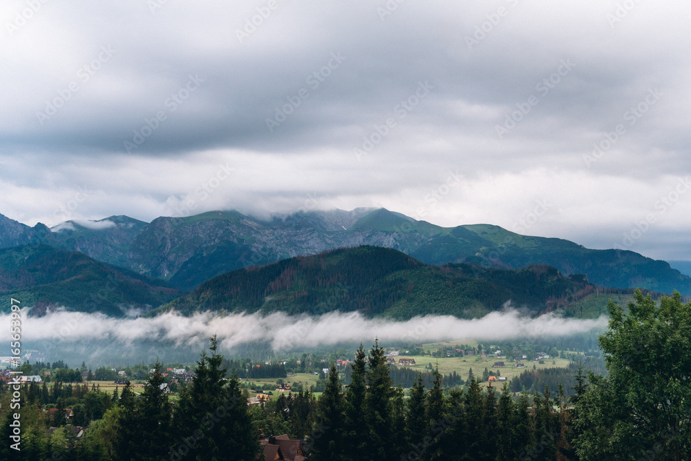 Beautiful landscape of cloudy mountains near the village